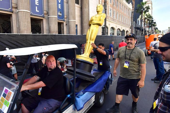 A statue of the Oscar is placed for transportation along Hollywood Boulevard as preparations for the red carpet arrivals area continued March 25.