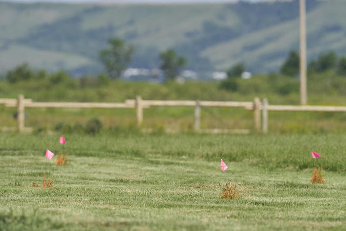 Flags mark the spot where the remains of over 750 children were buried on the site of the former Marieval Indian Residential School in Cowessess first Nation, Saskatchewan, June 25, 2021. More than 750 unmarked graves have been found near a former Catholic boarding school for indigenous children in western Canada.