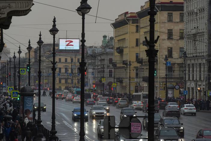 A screen on the roof of a building in central St. Petersburg, Russia, displays the symbol "Z" and a slogan reading: "We don't give up on our people" on Friday.
