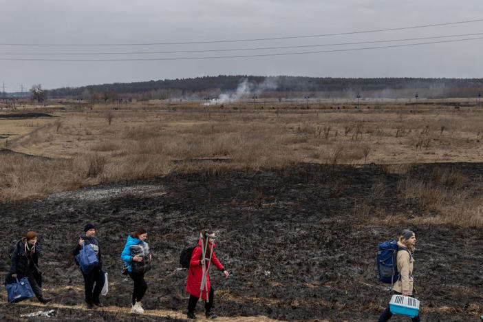 Residents of Irpin, Ukraine, flee heavy fighting via a destroyed bridge as Russian forces entered the city on March 7. On Monday, Ukraine said it was closing humanitarian corridors out of concern about Russian provocations.