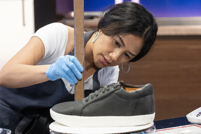 April Julian on <em>Is it Cake?, </em>measuring a cake made in the image of a shoe.