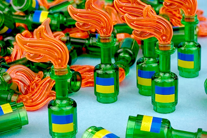 Mini figurines based on Molotov cocktails, featuring the Ukrainian flag sold for $20 each, with proceeds donated to a non-profit aid group, Direct Relief.