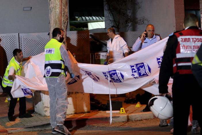 Israeli security forces gather at the site of an attack that left two Israeli police dead in the northern city of Hadera on Sunday.