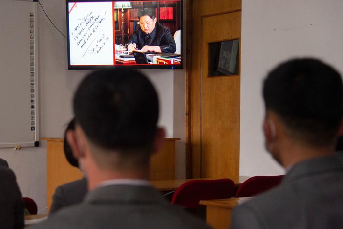In this photo taken in Pyongyang, North Korea, on March 25, 2022, students of the Pyongyang Jang Chol Gu University of Commerce watch footage of North Korean leader Kim Jong-Un along with news of the previous day's launch of the Hwasong-17 missile — Pyongyang's first ICBM test since 2017.