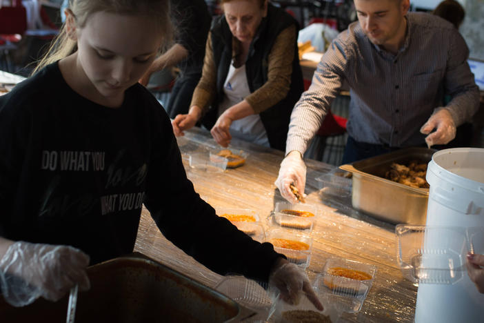 Volunteers, many of them forced to flee the war in other parts of Ukraine, pack meals for members of the country's Territorial Defense Forces in Moderna restaurant in Dnipro, Ukraine.