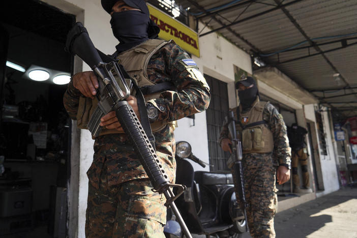 Military guard a custody center in San Salvador, El Salvador, on Tuesday.