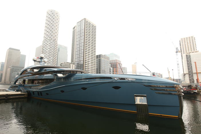 The newly-detained superyacht Phi is pictured while docked in Canary Wharf in east London on Tuesday.