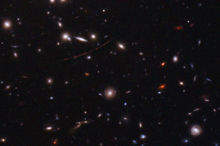The Hubble Space Telescope has spotted the farthest star ever seen. The magnified galaxy looks like a stretched out red line with three dots. The single star is the middle one.