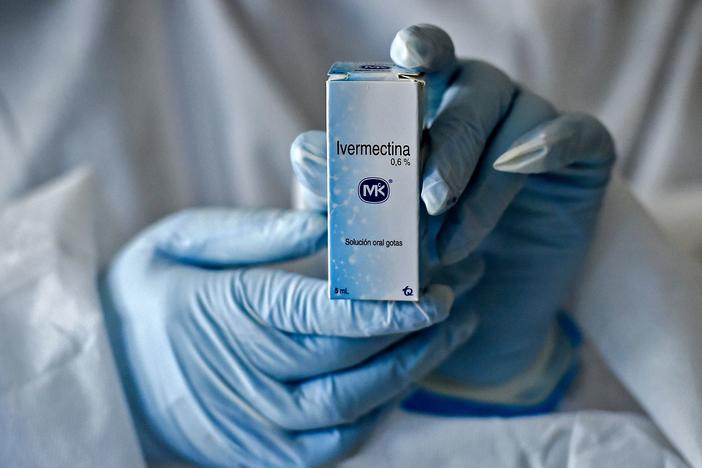 A health worker shows a box containing a bottle of Ivermectin in Cali, Colombia, on July 21, 2020.