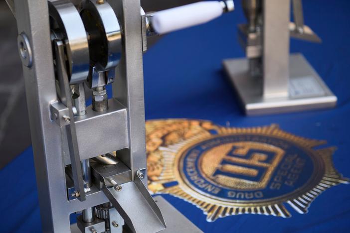 A pill press machine seized by authorities is displayed during a news conference outside the Roybal Federal Building in February 2021 in Los Angeles.