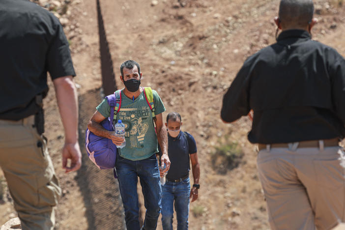 Customs and Border Protection agents apprehend a group of Brazilian migrants in Otay Mesa, Calif., in August 2021.