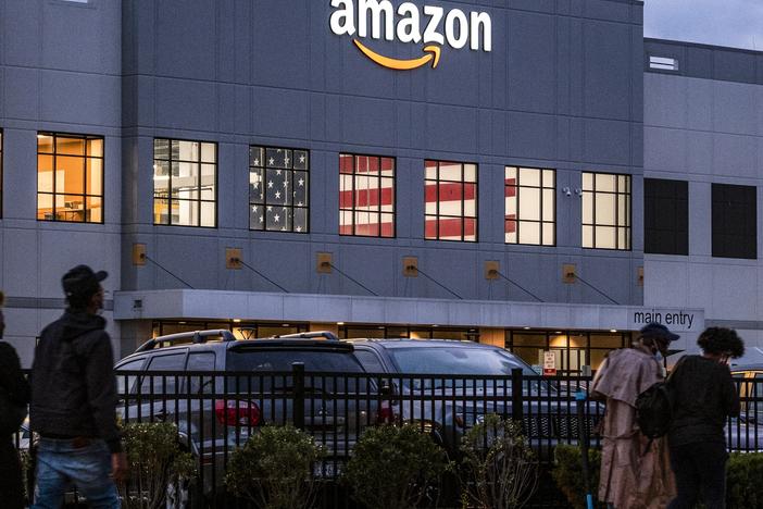 People arrive for work at the Amazon distribution center at the New York City borough of Staten Island on Oct. 25, 2021.