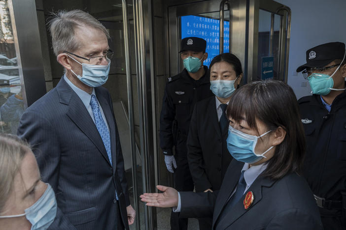 Australian Ambassador to China Graham Fletcher, left, is turned away by court officials and police as he tried to enter the trial of Chinese Australian journalist Cheng Lei at the Beijing Number 2 Intermediate People's Court on Thursday in Beijing.