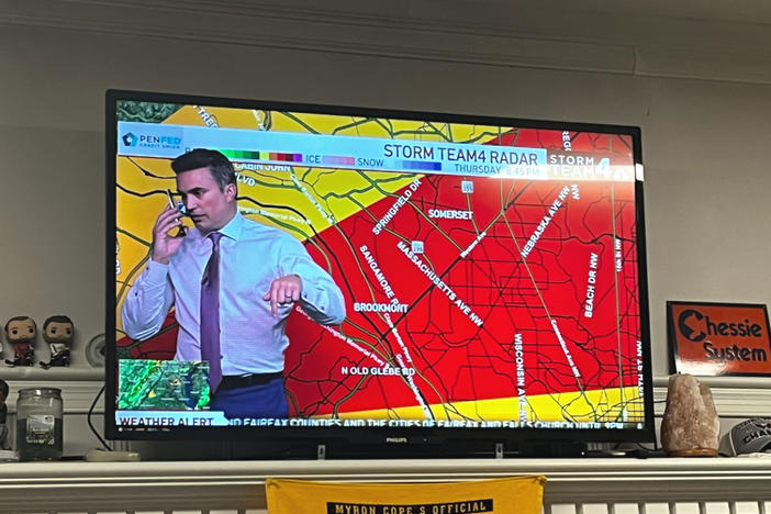 Meteorologist Doug Kammerer pauses his live weather broadcast to warn his family about a tornado warning.