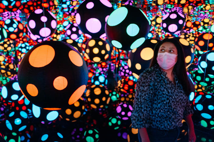 Visitor experiencing Yayoi Kusama's<em> Infinity Mirrored Room—My Heart Is Dancing into the Universe</em> (2018), part of the 2022 exhibition<em> One with Eternity: Yayoi Kusama in the Hirshhorn Collection </em>at the Hirshhorn Museum and Sculpture Garden.