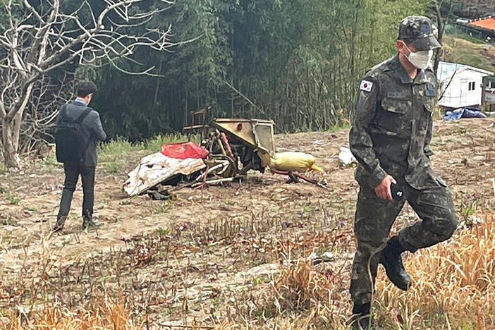 Debris from the South Korean Air force's KT-1 trainer aircraft collision are seen at a field in Sacheon, South Korea, Friday, April 1, 2022.