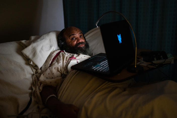 Maurice Miller lies in bed in his room at a nursing home in Takoma Park, Md., on Thursday. The Biden administration is planning to establish a federal minimum staffing requirement for nursing homes as part of a broader push to improve care for seniors and people with disabilities.