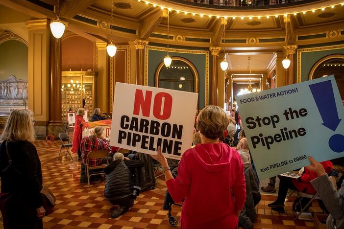More than 100 farmers gathered in the rotunda of the Iowa Capitol in Des Moines to protest three carbon pipelines proposed in Iowa.