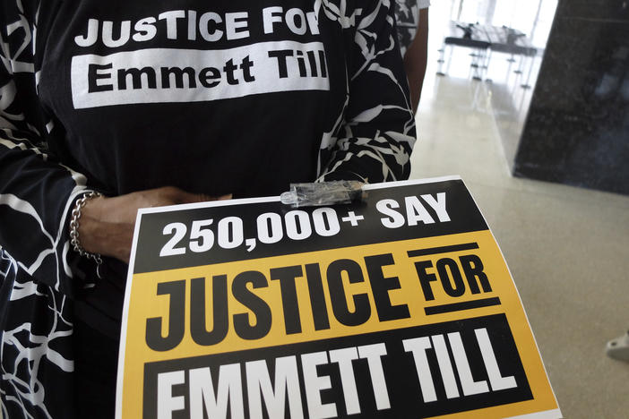 Deborah Watts, a cousin of Emmett Till, the Black 14-year-old from Chicago who was abducted, tortured and lynched after he allegedly whistled at a white woman, holds a poster on March 11, in Jackson, Miss.