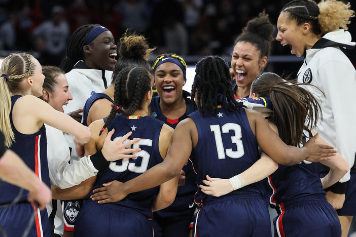 The UConn Huskies celebrate after defeating the Stanford Cardinal 63-58 during the 2022 NCAA Women's Final Four semifinal game Friday at Target Center in Minneapolis.