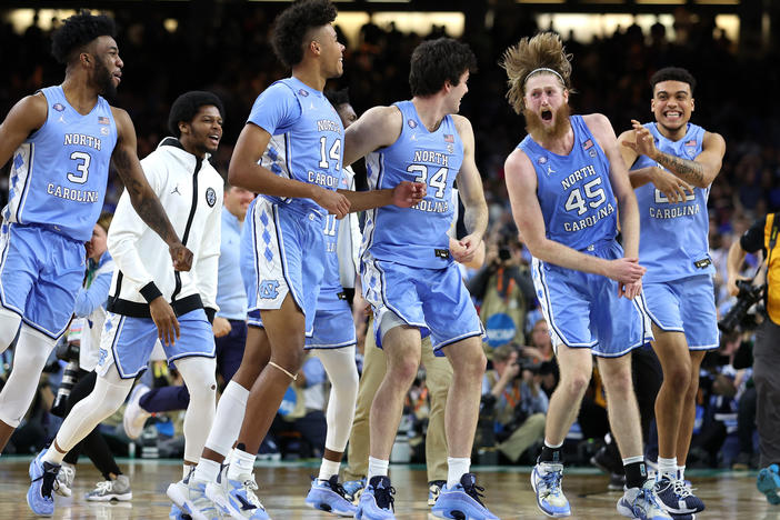 The North Carolina Tar Heels react after defeating the Duke Blue Devils 81-77 on Saturday, advancing to the final game of the 2022 NCAA Men's Basketball Tournament.