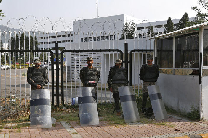 Pakistani paramilitary troops stand guard with riot gears outside the National Assembly, in Islamabad, Pakistan, Sunday, April 3, 2022.