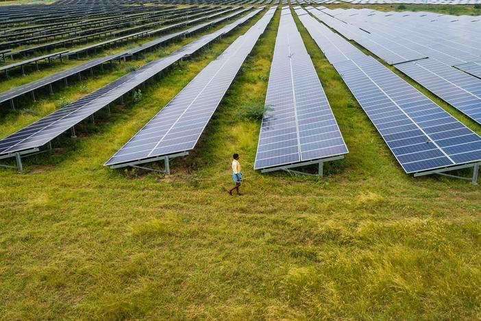 The report finds the world's energy supply needs to shift to renewable sources, like this solar farm in Karnataka, India, but it's not happening fast enough.