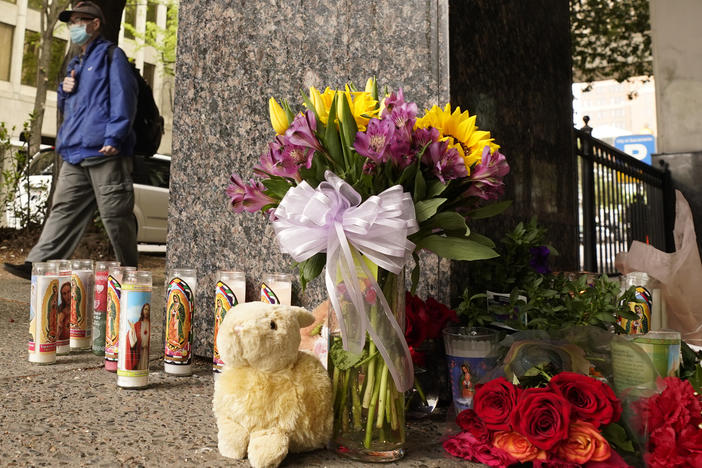 Flowers and votive candles make up a memorial near the location of Sunday's mass shooting in Sacramento, California.