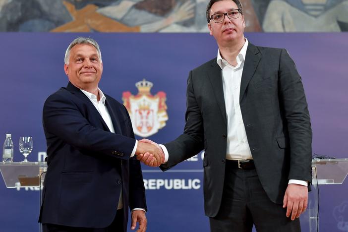 Hungarian Prime Minister Viktor Orban (left) and Serbian President Aleksandar Vucic shake hands after a joint press conference in Belgrade in 2020. Both men won reelection over the weekend.