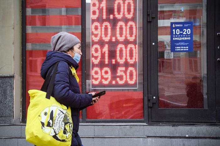 A woman walks past a currency exchange office in central Moscow on Feb. 24.