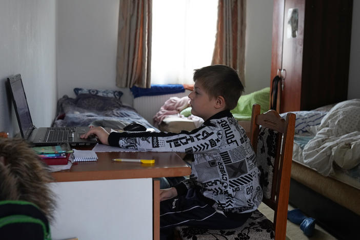 Dima, who fled the war in Ukraine with his mother, attends an online class, at the "Saint John the Baptist" Monastery in Ruscova, where 12 Ukrainians are currently being hosted, on March 30, 2022 in Ruscova, Romania.