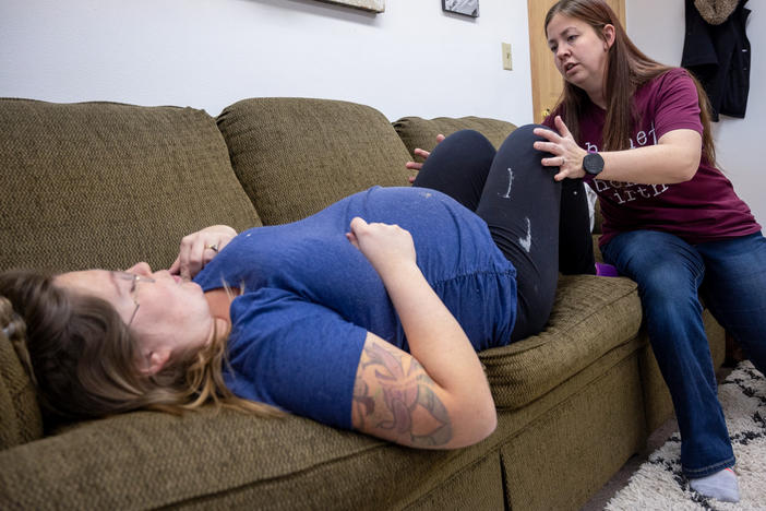 Bethany Gates, a certified professional midwife in Iowa, examines her client, Mandy King. King has three children and this will be her first home birth.