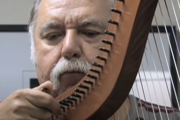 Francisco González, a founding member of Los Lobos, playing the Mexican harp
