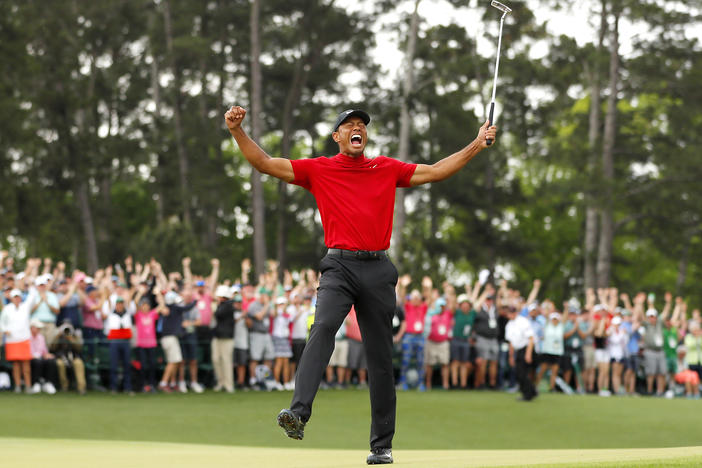 Tiger Woods celebrates after sinking his putt on the 18th green to win the Masters Tournament on April 14, 2019, in Augusta, Ga.