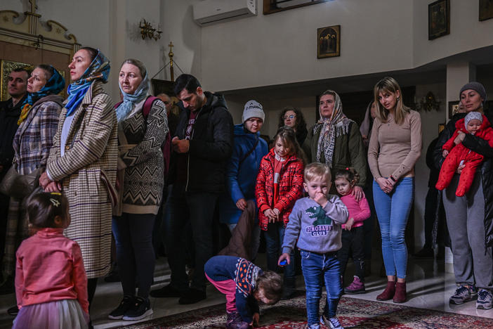People who fled the war in Ukraine and members of the Ukrainian diaspora pray in an Orthodox church in Krakow on Sunday.