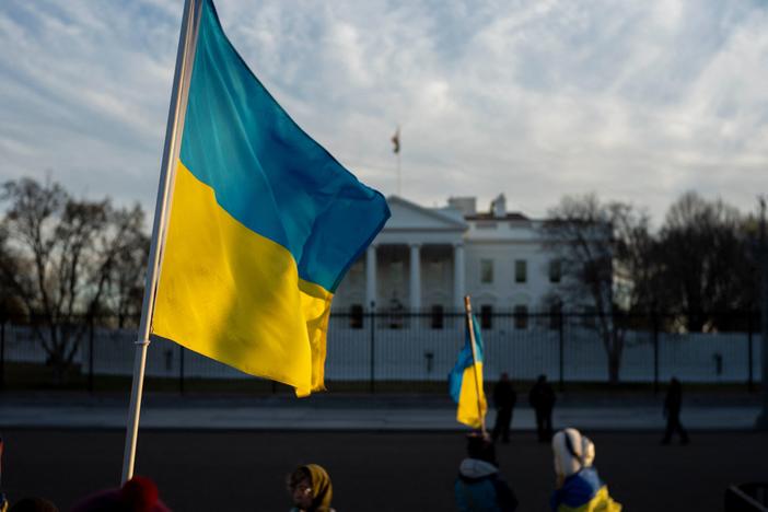 Activists hold Ukrainian flags as they protest against Russia's invasion of Ukraine during a rally at Lafayette Square, across from the White House, in Washington, D.C., on Feb. 25. New U.S. sanctions Sanctions are being enacted on top Russian officials and family members, including President Vladimir Putin's adult children.