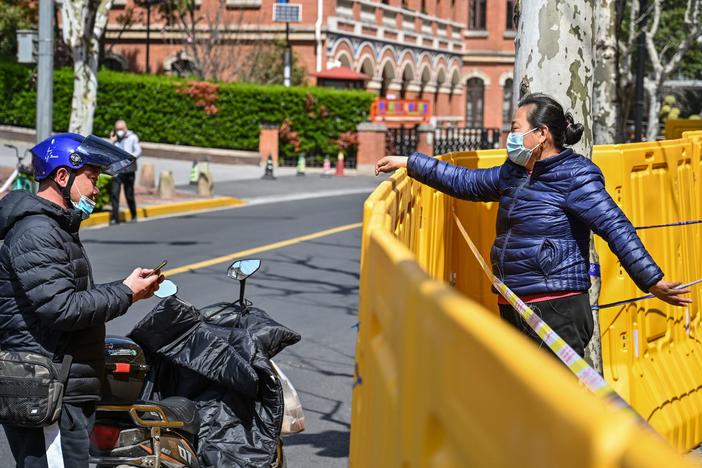 Neighborhoods are separated by barriers as part of lockdown measures in Shanghai to prevent the spread of the highly transmissible omicron variant.