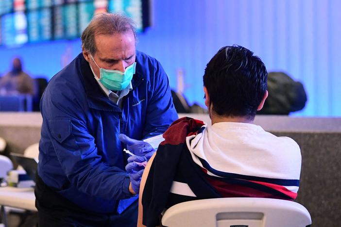 A pop-up clinic inside Los Angeles International Airport offered free vaccinations and boosters for holiday travelers last December. A new round of vaccinations may be needed before next winter.