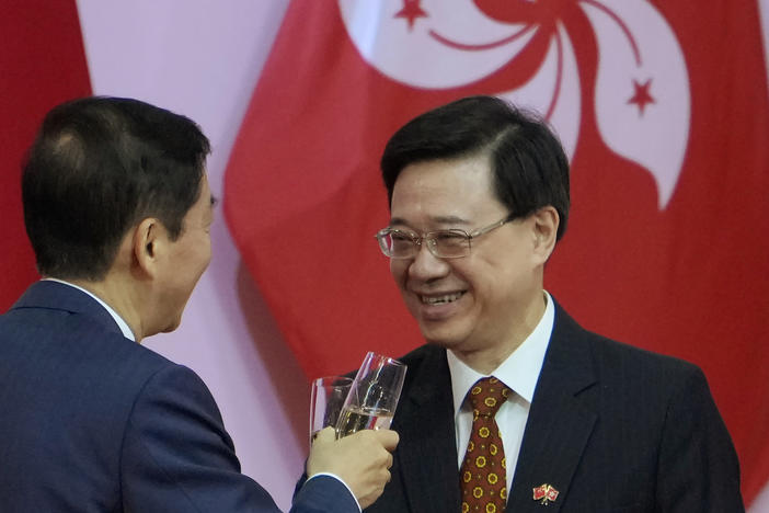 Hong Kong's Chief Secretary John Lee, right, attends a reception, following the flag-raising ceremony for the celebration of China's National Day, in Hong Kong on Oct. 1, 2021.