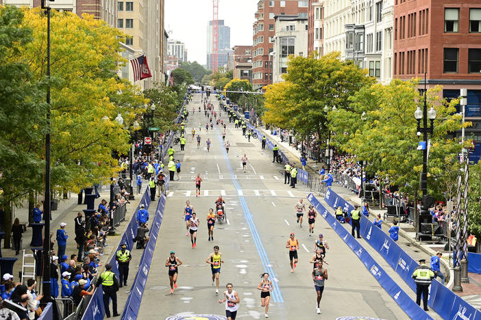 Runners near the finish line on Boylston Street during the 125th Boston Marathon on October 11, 2021 in Boston, Massachusetts. Runners residing in Russia and Belarus are banned from this year's event.