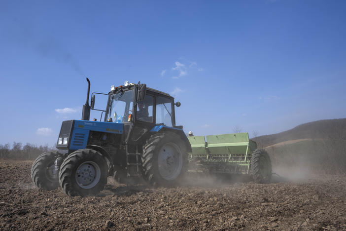 Workers plow wheat in Husakiv village in western Ukraine late last month. Russia and Ukraine account for a large percentage of global wheat exports.