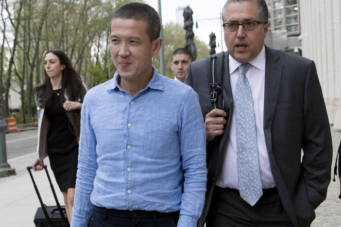 Former Goldman Sachs executive Roger Ng (center) leaves Brooklyn federal court with attorney Marc Agnifilo on May 6, 2019, in New York. On Friday, Ng was convicted of bribery and other corruption charges accusing him of participating in a $4.5 billion scheme to ransack the Malaysian state investment fund.