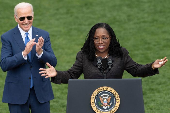 Judge Ketanji Brown Jackson speaks as President Biden reacts at an event celebrating Jackson's confirmation to the Supreme Court on the South Lawn of the White House on Friday.