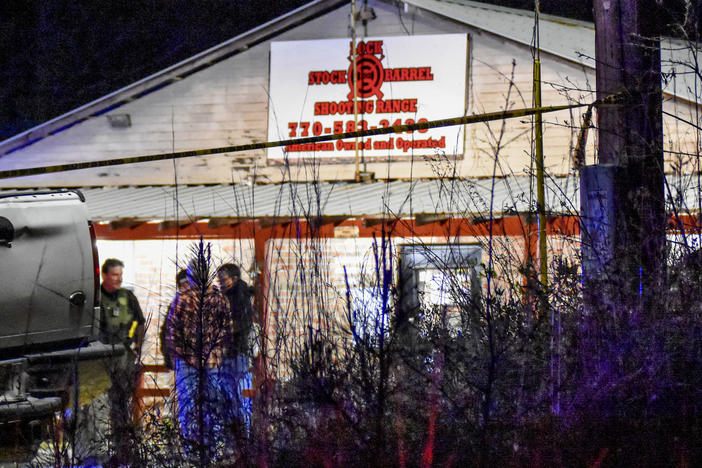 Law enforcement agents investigate the scene of a fatal robbery at Lock Stock & Barrel Shooting Range late Friday, April 8, 2022 in Coweta County, Ga., about 50 miles southwest of Atlanta.