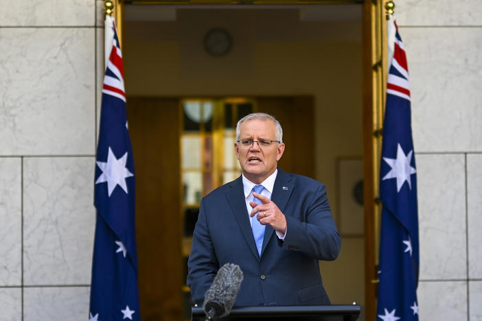Australian Prime Minister Scott Morrison gestures during a news conference at Parliament House in Canberra, Australia, Sunday, April 10, 2022.
