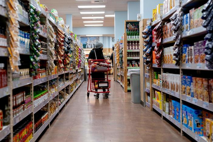 A shopper walks through a grocery store in Washington, D.C, on March 13. Surging inflation poses a particular challenge for working-class families, impacting the cost of basic necessities such as groceries.