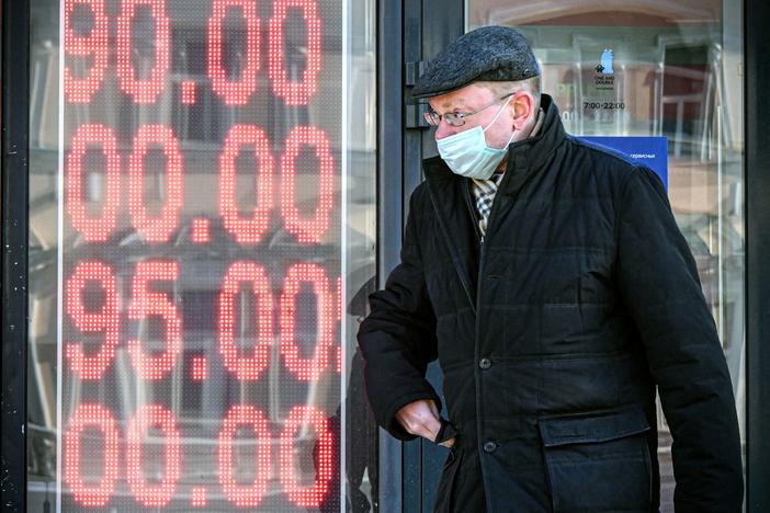 A man walks past a currency exchange office in central Moscow on Feb. 28. The U.S. and its allies have imposed severe economic sanctions on Russia since its invasion of Ukraine.