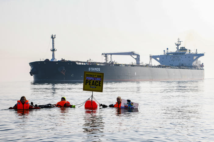 Activists demonstrate in front of a ship carrying Russian oil in the Baltic Sea this spring. The U.S. has imposed sanctions on Russian oil. However, most countries have not, and refineries around the world still import Russian oil.