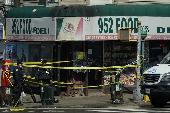 Members of the New York Police Department and emergency vehicles crowd the streets near a subway station in the Brooklyn borough of New York on Tuesday.