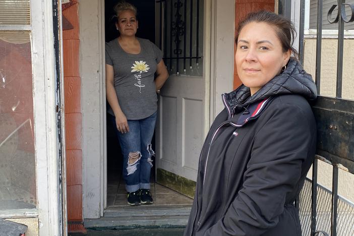 Marisela Orozco (foreground) is letting her sister, Marissa, live in the house she thought she would own after making almost four years of payments. But the owner disappeared, along with the title, and she worries he may return and evict them.